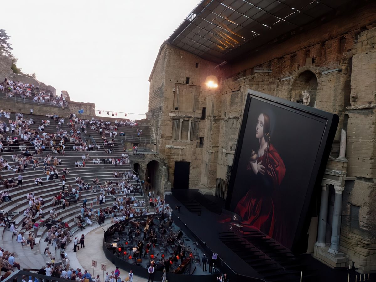 Le superbe mur du Théâtre Antique d'Orange en partie caché par le tableau de Tosca.