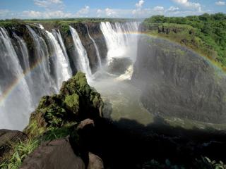 Voyage en AFRIQUE DU SUD en 2013. Visite des chutes VICTORIA entre ZAMBIE et ZIMBABWE.
Ceux qui sont allés la bas ont sans doute pu observer ce "phénomène naturel insolite" suivant l'endroit ou l'on se trouve et si pas trop de brouillard formé par les chutes et surtout suivant l’époque ou l'on fait le voyage, car si trop de débit le brouillard formé empêche d'observer ce phénomène. Si par bonheur et que l'on a cette chance on observe par moments un arc en ciel qui traverse le fleuve ZAMBÈZE et qui fait un pont entre les deux pays. C'est magique. Quand j'ai proposé le thème j'ai tout de suite pensé à ce cliché qui nous a particulièrement marqué par sa beauté.