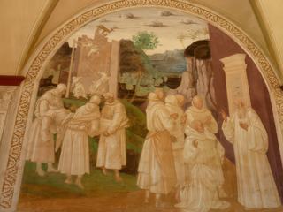 Benoit ressuscite un jeune moine sur lequel était tombé un mur (Fresque due à Signorelli) Encore une fois saint Benoit a gagné contre le Diable qui était responsable de l'écroulement du mur.