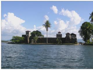 Depuis le bateau, vue sur le fort de Castillo San Felipe. Bâti en 1682 à l'entrée du Lac Izabal pour se défendre des pirates des Caraïbes, il fut ensuite transformé en prison, puis incendié et finalement reconstruit selon l'original au cours des années 1950.